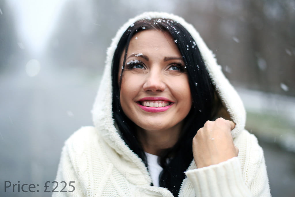 girl in winter on the street under the snow